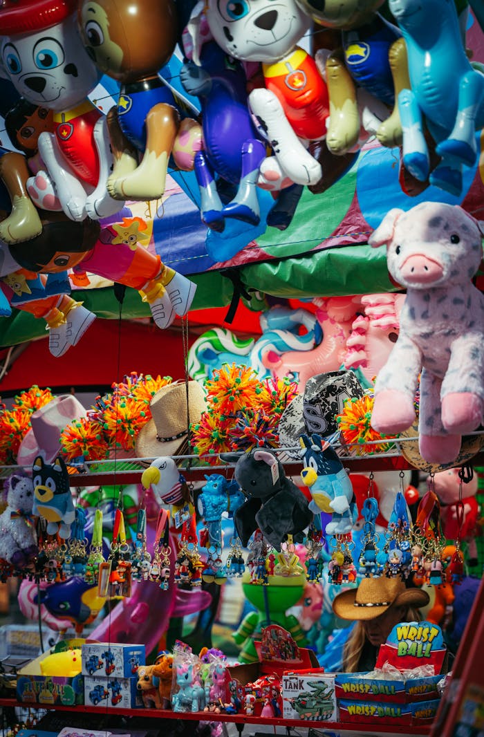 Vibrant display of plush toys and inflatables at a lively fairground stall.